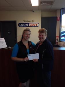 Band Secretary Heather McMillan accepts the cheque for $1000 on behalf of the band.