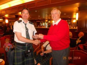 Retired President George Brown accepts his Life Membership from a disheveled Pipe Major Angus Beath